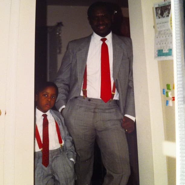 Christopher as a child beside his father, both in suits